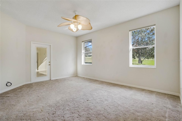 carpeted empty room with ceiling fan