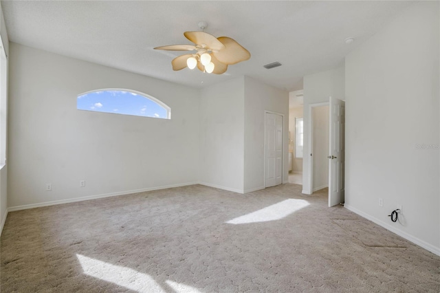 empty room featuring light carpet and ceiling fan