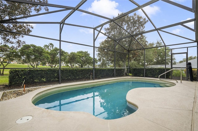 view of pool featuring glass enclosure and a patio area