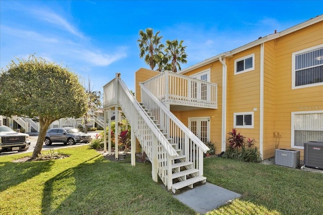 exterior space featuring a lawn, a deck, and central AC