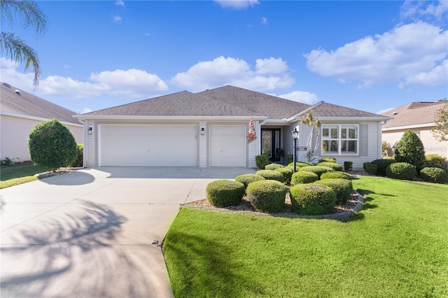 ranch-style house featuring a garage and a front yard