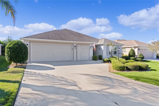 single story home with a front yard and a garage