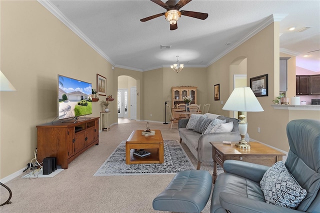 carpeted living room featuring ceiling fan with notable chandelier and crown molding