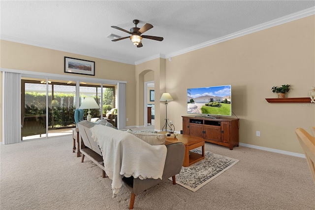 living room featuring a textured ceiling, ceiling fan, crown molding, and light carpet