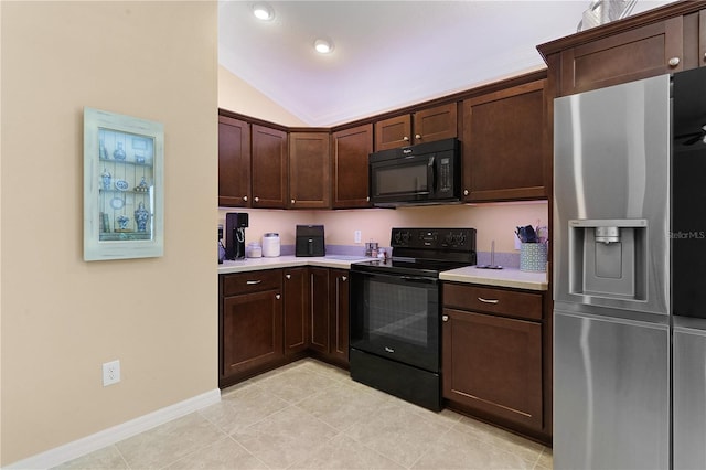 kitchen featuring dark brown cabinetry, light tile patterned floors, black appliances, and vaulted ceiling