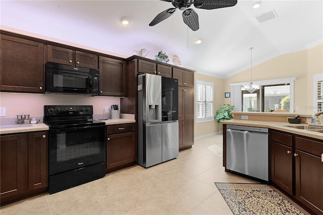 kitchen featuring dark brown cabinets, hanging light fixtures, black appliances, and lofted ceiling