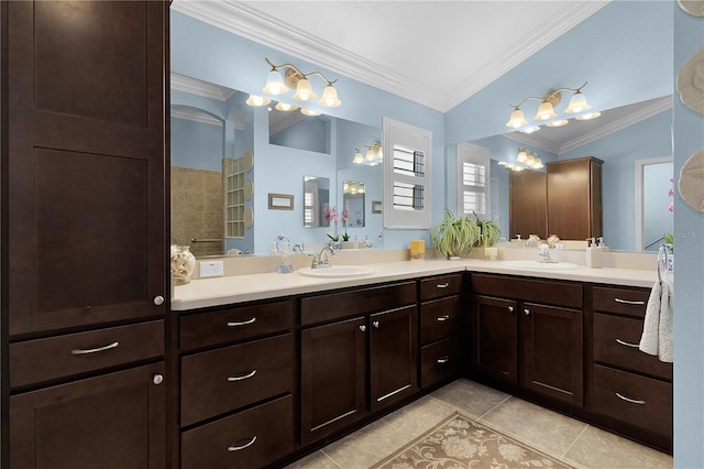 bathroom featuring tile patterned flooring, vanity, ornamental molding, and lofted ceiling