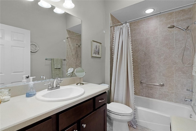 full bathroom with vanity, shower / tub combo, and toilet