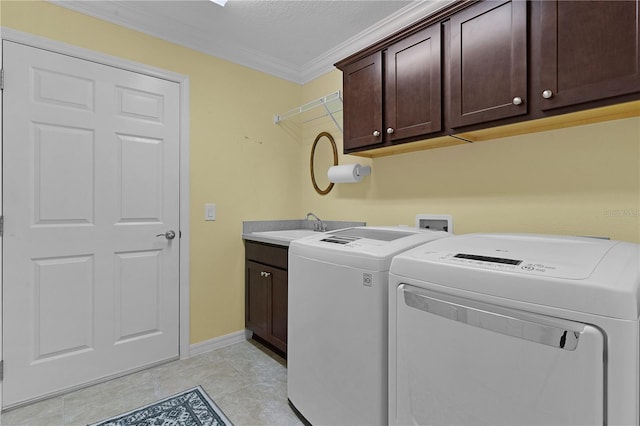 laundry room featuring cabinets, crown molding, sink, light tile patterned floors, and independent washer and dryer