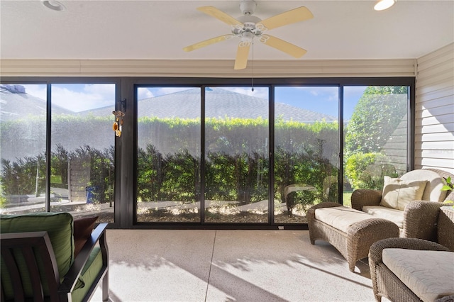 sunroom / solarium featuring a mountain view, ceiling fan, and a wealth of natural light