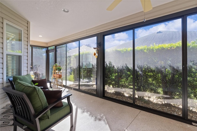 sunroom / solarium featuring ceiling fan and a healthy amount of sunlight