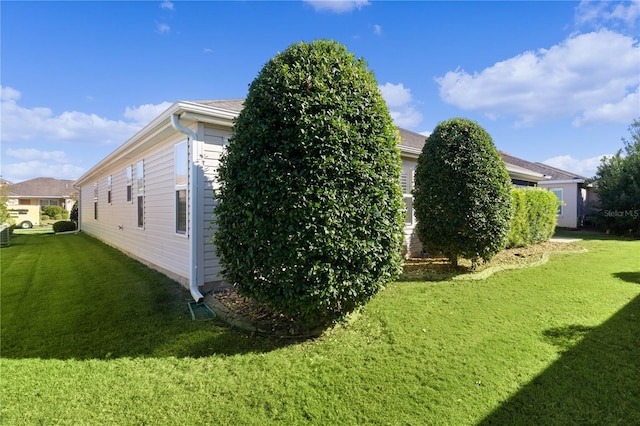 view of side of property featuring a yard