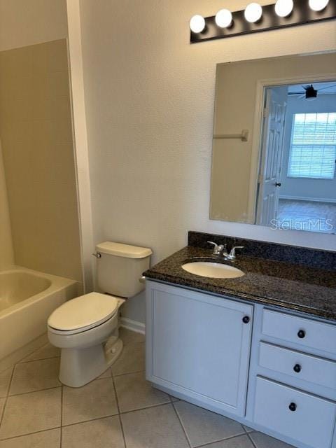 full bathroom with ceiling fan, tile patterned flooring, toilet, shower / tub combination, and vanity