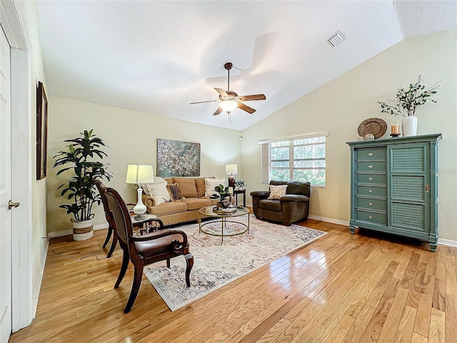 living room with light hardwood / wood-style flooring, ceiling fan, and lofted ceiling