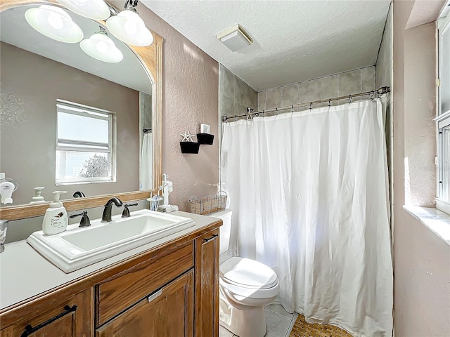 bathroom with vanity, tile patterned floors, toilet, a textured ceiling, and walk in shower