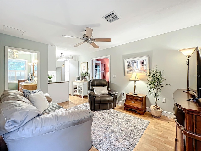 living room featuring ceiling fan and light wood-type flooring