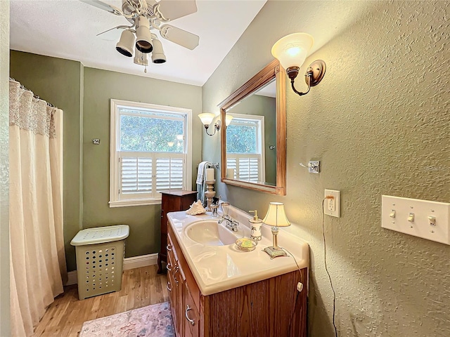 bathroom featuring vanity, hardwood / wood-style flooring, and ceiling fan