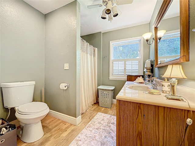 bathroom featuring hardwood / wood-style floors, vanity, ceiling fan, and toilet