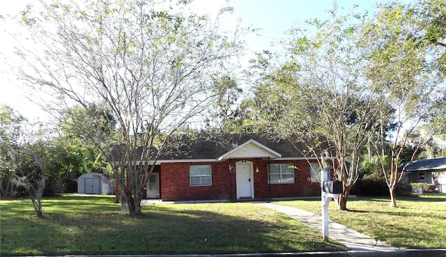 single story home featuring a front lawn and a storage unit