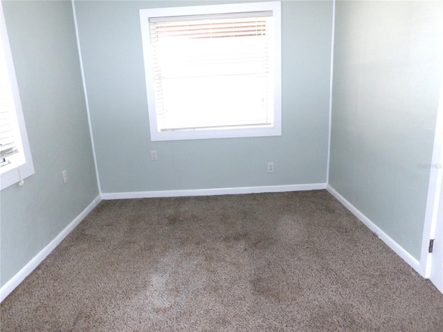 carpeted spare room with plenty of natural light