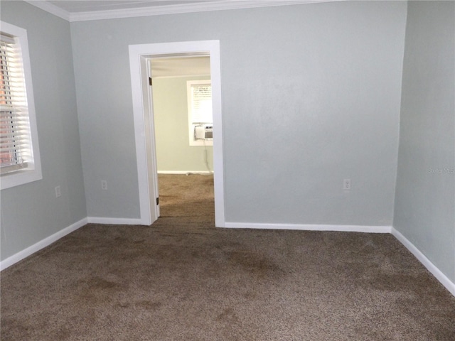 carpeted spare room featuring cooling unit and ornamental molding