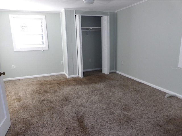 unfurnished bedroom featuring carpet flooring and a closet