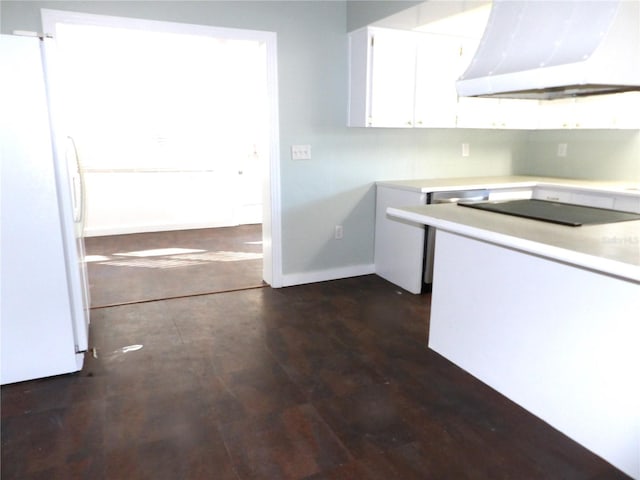 kitchen with dark wood-type flooring, white refrigerator, black electric stovetop, white cabinets, and exhaust hood