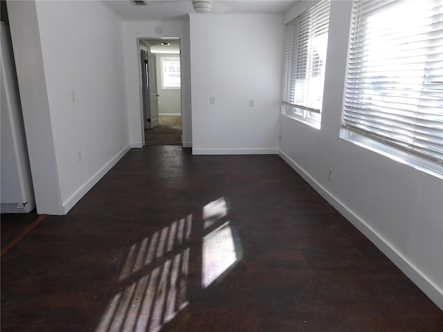 spare room with dark hardwood / wood-style floors