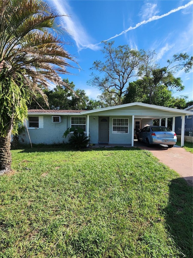 single story home featuring a front yard and a carport