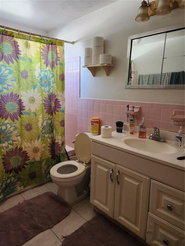 full bathroom featuring vanity, tile patterned flooring, toilet, tile walls, and shower / tub combo with curtain