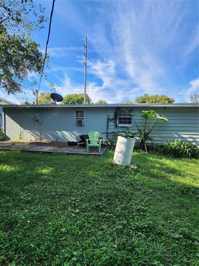 3 E Lemon St, Beverly Hills, FL 34465 - back of property featuring a lawn