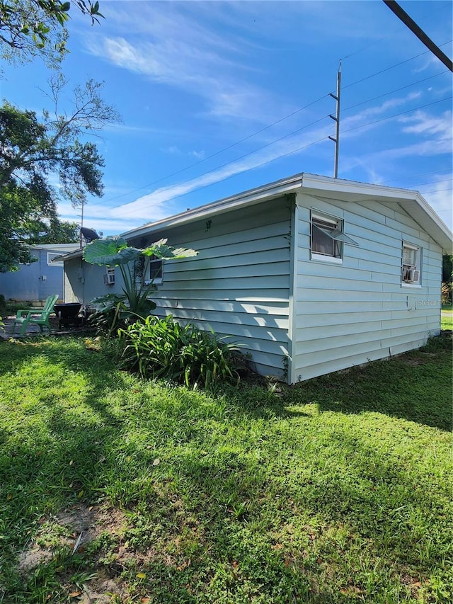 view of side of home featuring a yard