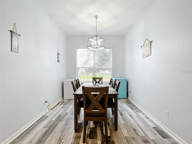 dining area with a notable chandelier and light wood-type flooring