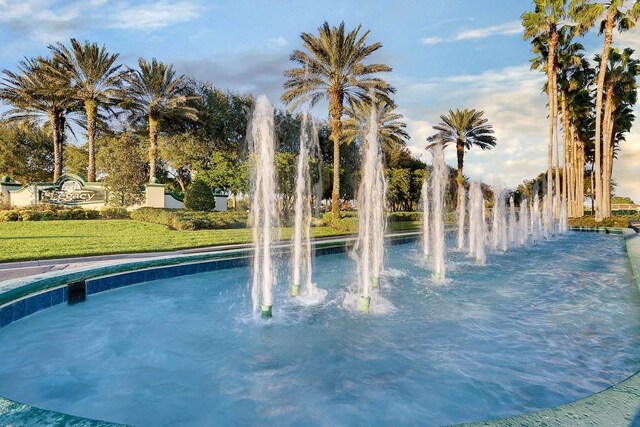 view of swimming pool featuring a lawn