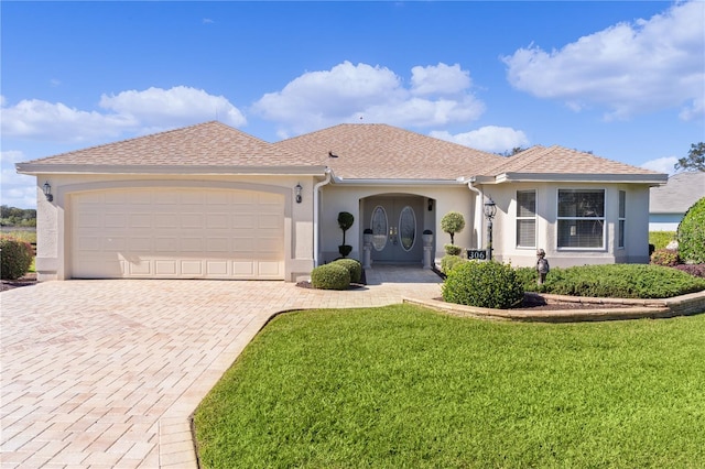 ranch-style home featuring a front yard and a garage