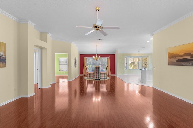 interior space with ornamental molding, ceiling fan with notable chandelier, a textured ceiling, sink, and hardwood / wood-style floors