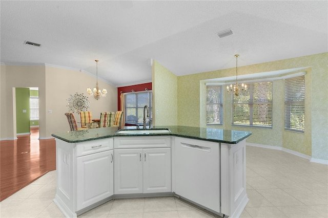 kitchen featuring white cabinets, a chandelier, plenty of natural light, and sink