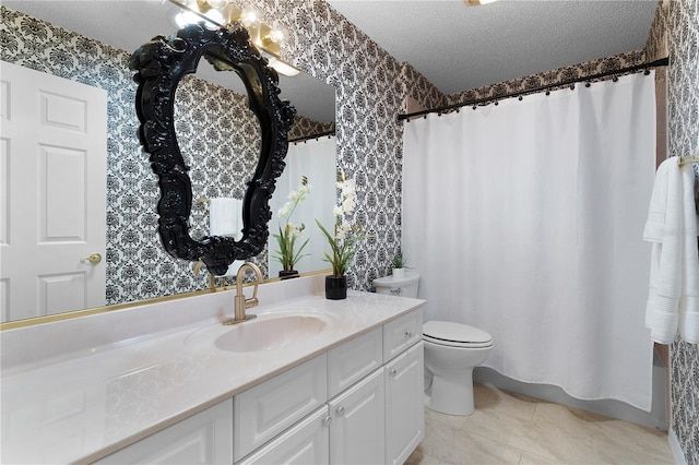 bathroom with tile patterned flooring, vanity, toilet, and a textured ceiling