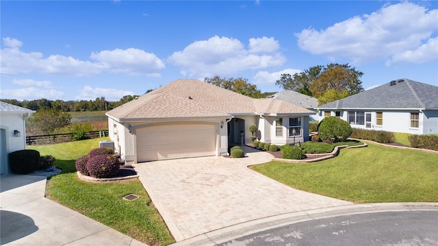 ranch-style house featuring a front lawn and a garage