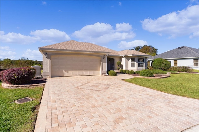 ranch-style home with a front yard and a garage