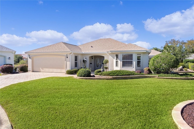 mediterranean / spanish-style home with a front lawn and a garage