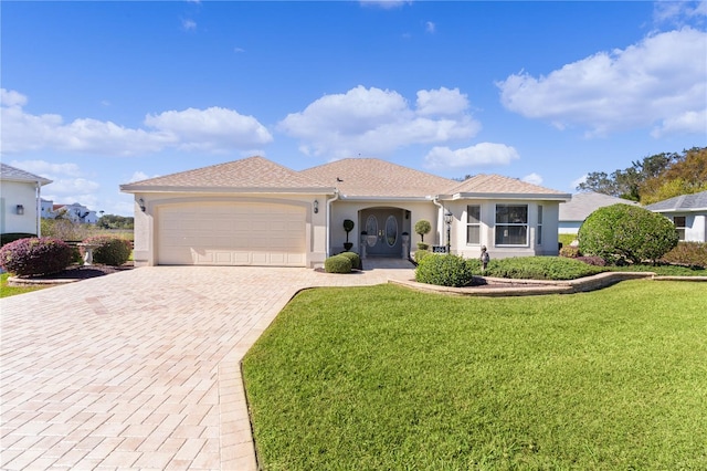 mediterranean / spanish-style home with a garage and a front lawn