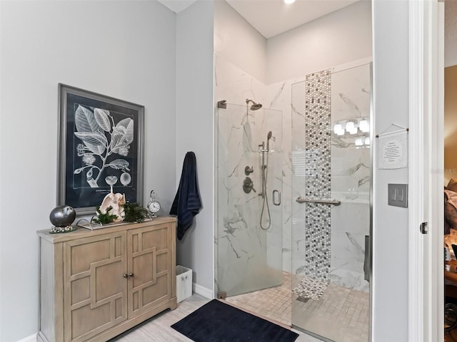 bathroom featuring a shower with shower door