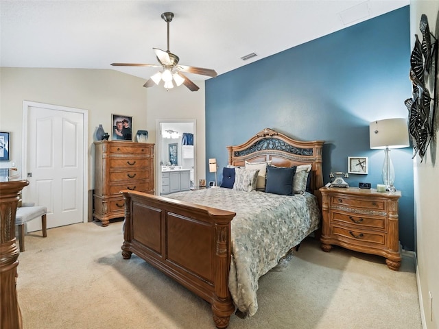 carpeted bedroom with ceiling fan, ensuite bathroom, and lofted ceiling