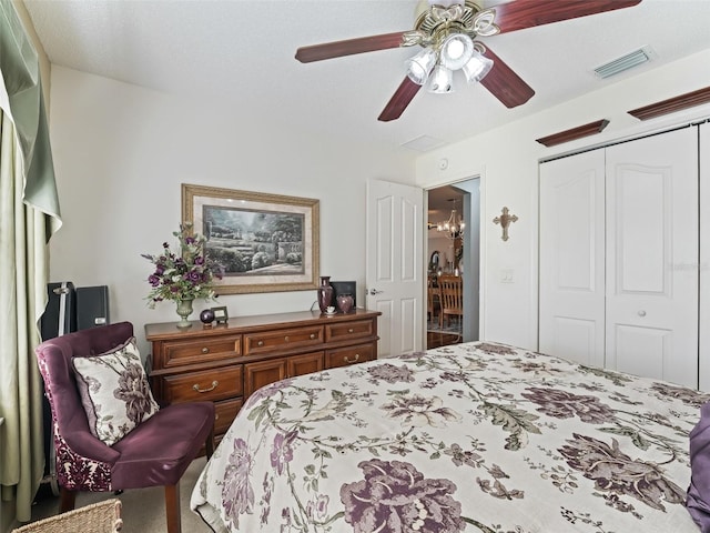 carpeted bedroom with ceiling fan and a closet