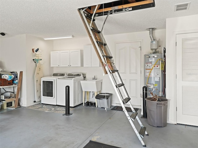 garage with washer and clothes dryer and gas water heater