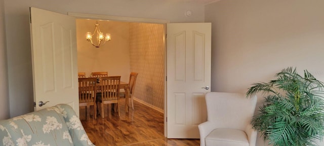 dining space with a notable chandelier and hardwood / wood-style floors