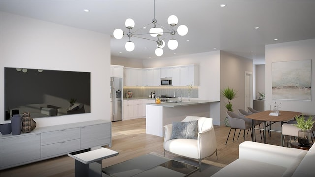 interior space with sink, light wood-type flooring, and an inviting chandelier