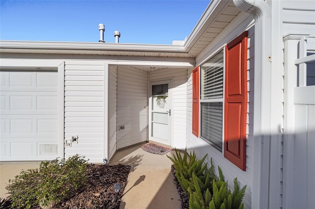 view of exterior entry with a garage