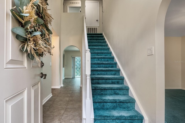 stairs featuring tile patterned flooring